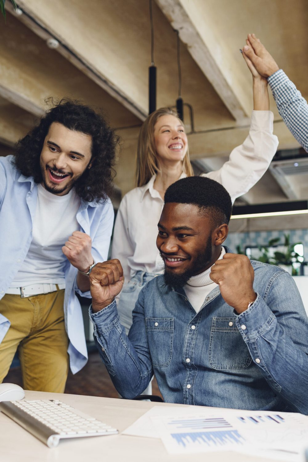 Happy overjoyed business team celebrate corporate victory in their office
